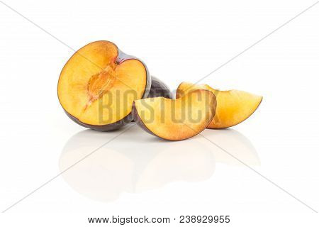 Two Red Blue Plum Slices And One Half Isolated On White Background