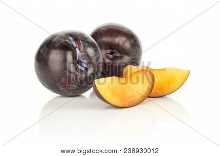 Two Red Blue Plums And Slices Isolated On White Background