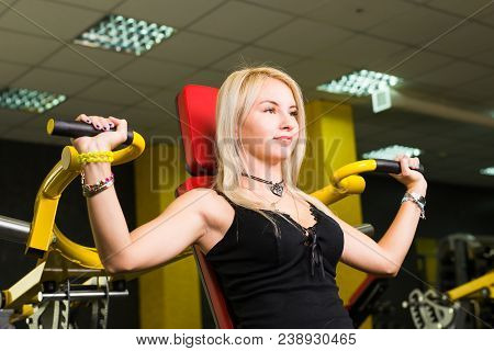 Sport, Fitness, Lifestyle And People Concept - Close Up Of Young Woman Flexing Muscles On Cable Gym 
