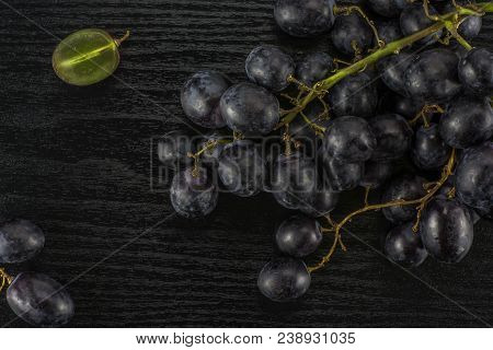 Black Grape Clusters (autumn Royal Variety) With One Sliced Berry Table Top Isolated On Black Wood B