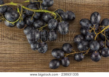 Black Grapes Cluster (autumn Royal Variety) Table Top Isolated On Brown Wood Background