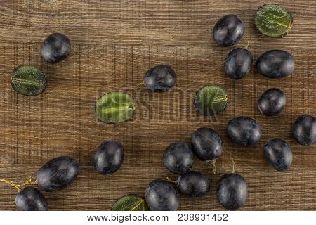 Black Grape Berries (autumn Royal Variety) Table Top Isolated On Brown Wood Background Some Sliced