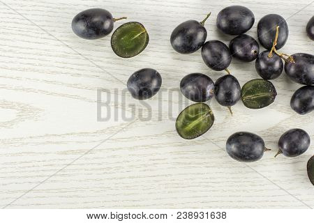 Black Grape Berries (autumn Royal Variety) Some Sliced Table Top Isolated On Grey Wood Background