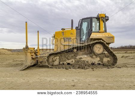 Yellow Bulldozer At A Loamy Construction Site