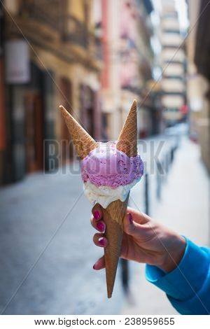A Woman Sitting And Holding An Ice Cream. Summer Time In The Street Of The Old City. Close Up Shot