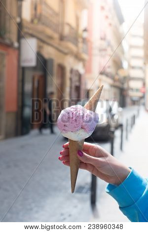 A Woman Sitting And Holding An Ice Cream. Summer Time In The Street Of The Old City