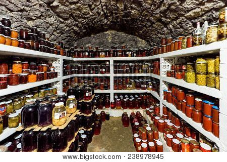 Traditional Cellar Full Of Food Bottles On Shelves
