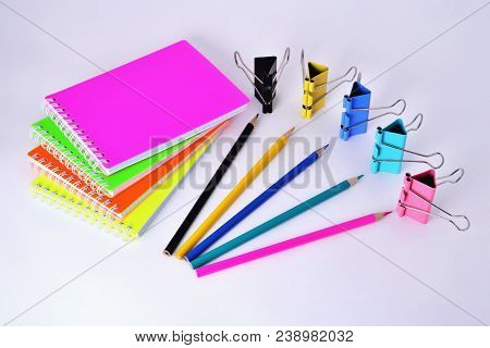 Colorful Notepads Clip For Paper And Pencils On A White Background In The Correct Geometry