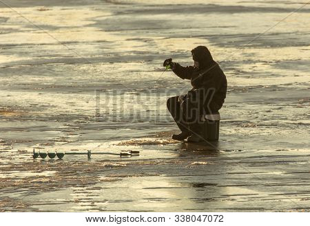 Lipetsk, Russia - December 6, 2019: A Man Catches Fish On Ice In The Morning At The Matyr Reservoir.