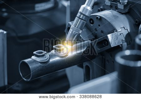 The Abstract Scene Of Robotic Arm Welding Machine . The Hi Technology Automotive Parts Manufacturing