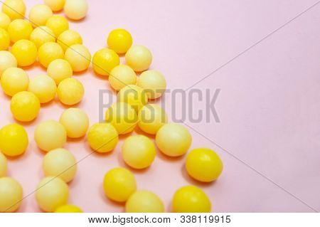 Yellow Colorful Round Dragees Of Vitamin C, Ascorbic Acid On Pink Background, Copy Space