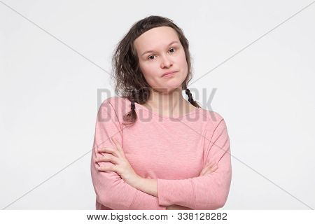 Serious Young Female Student In Pink Clothes Ooking At Camera, Her Eyes Full Of Distrust And Disappo