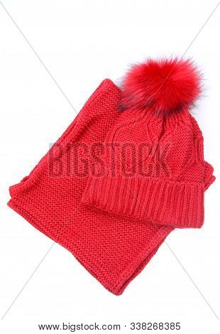 Knitted Red Colored Hat And Scarf On White Wood Background. Fashionable Warm Clothes For Girl Or Wom