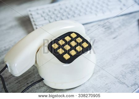 Vintage Phone On The Gtay Desk Background