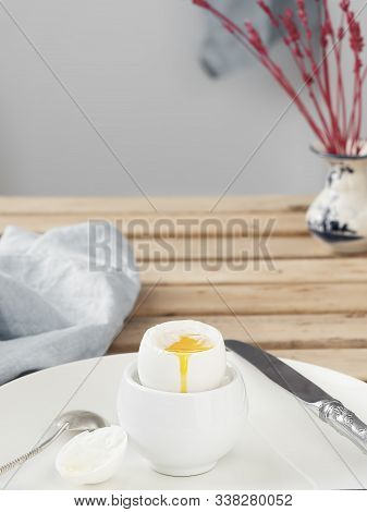 Soft-boiled Egg, White Egg On A Wooden Brown Table. White Ceramic Plate With Soft-boiled Egg. Mornin