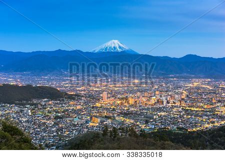 Kofu, Japan skyline with Mt. Fuji at dusk.