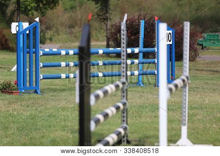 Image Of Show Jumping Poles On Empty Training Field. Wooden Barriers For Jumping Horses As A Backgro