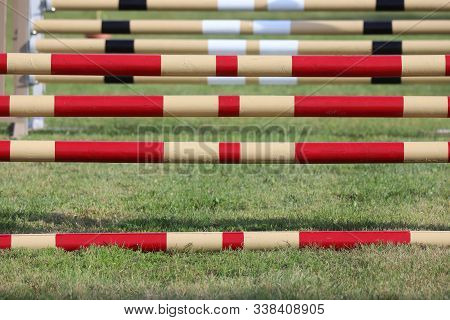 Image Of Show Jumping Poles On Empty Training Field. Wooden Barriers For Jumping Horses As A Backgro