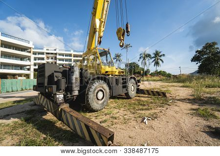 Yellow Automobile Crane With Risen Telescopic Boom Outdoors. Mobile Construction Crane On A Construc