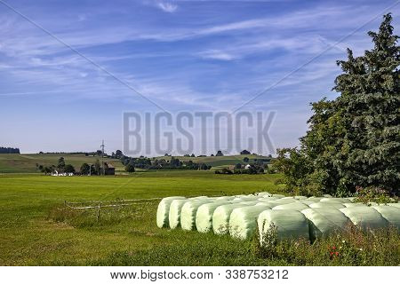 Hay Bales That Are Packed With Foil Store In A Meadow For Winter Fodder
