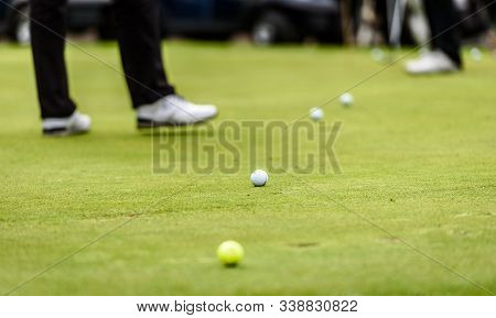 Golfer Legs At Golf Tournament Practice Swing With Golf Club.