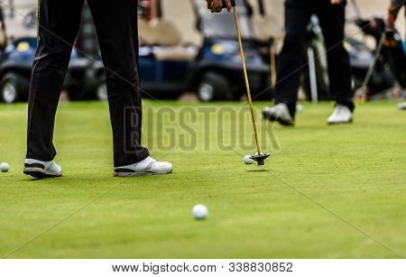 Golfer Legs At Golf Tournament Practice Swing With Golf Club.