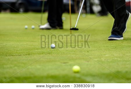Golfer Legs At Golf Tournament Practice Swing With Golf Club.