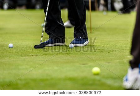 Golfer Legs At Golf Tournament Practice Swing With Golf Club.