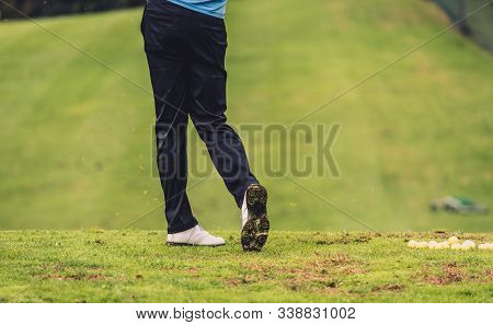 Golfer Legs At Golf Tournament Practice Swing With Driver.