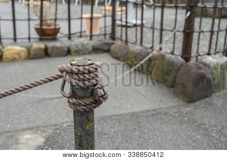 Rope Tied To A Natural Background Symbolizes The Concept
