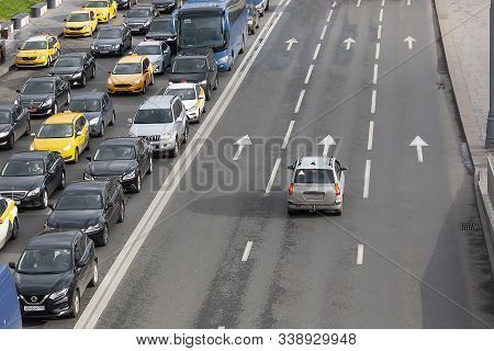 Moscow, Russia - October 22, 2019: Traffic Jam In Moscow. Cars On The Busy Road And One Car On A Fre