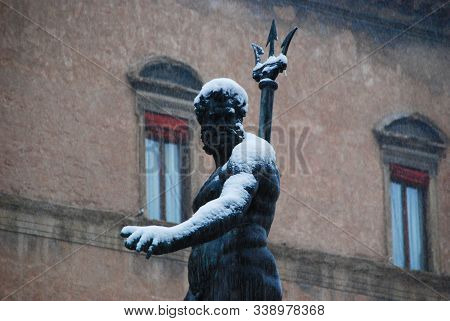 Neptune Fountain In Bologna Under The Snow. Snowfall In Bologna, Italy