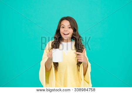 Starting Day With Breakfast. Small Kid Turquoise Background. Little Girl Drink Cocoa Or Milk Before 