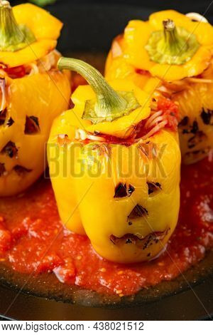 Jack O Lanterns Stuffed Yellow Pepper For Halloween.