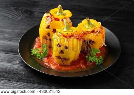Jack O Lanterns Stuffed Yellow Pepper For Halloween.