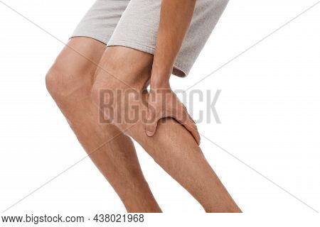 Cropped Young Caucasian Male Suffering From Muscle Pain And Pressing Hands To Leg