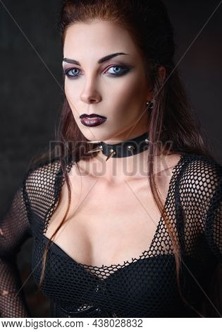 Portrait Of The Cute Goth (deathrock) Girl Dressed In Holey Blouse, Bra And Spiked Collar. Dark Beau