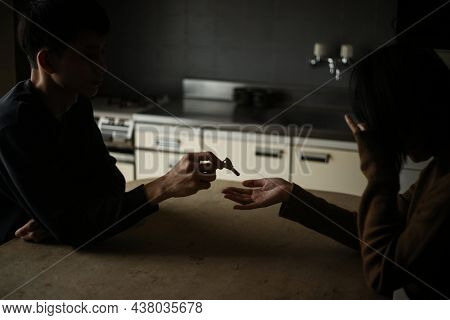 A Man Giving A Key To A Woman