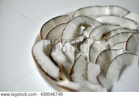 Slicing And Shavings Of Coconut On A White Plate