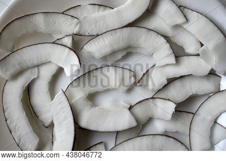 Slicing And Shavings Of Coconut On A White Plate