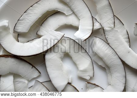 Slicing And Shavings Of Coconut On A White Plate