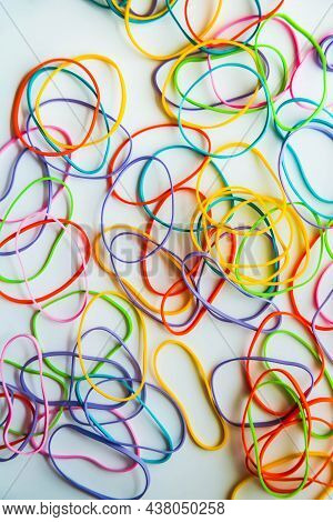 Top View Of Colorful Rubber Bands Isolated On White. Rainbow Elastic Rubber Bands On White. Space Fo