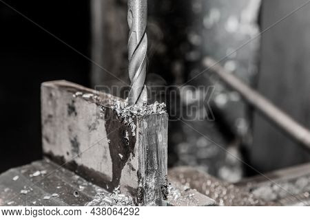 Thick Drill Drilling Old Iron Bar, Steel Work Equipment Close-up.