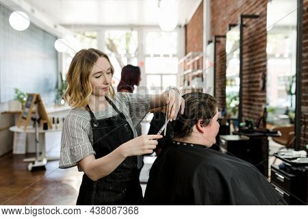 Hairstylist set the customer hair in a perm