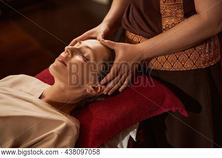 Experienced Masseuse Stimulating Acupoints On Her Patient Head