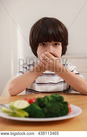 Cute Little Boy Covering Mouth And Refusing To Eat Vegetables At Home