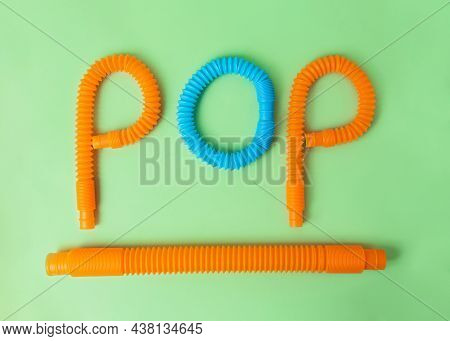 Composition From Antistress Toys - Pop Tubes.word Pop And Tube Under It.funny Finger Game.