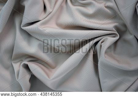 Draped Canvas Closeup. Abstract Polyester Fabric Background. Top View Of Fabric With Many Folds. Wav