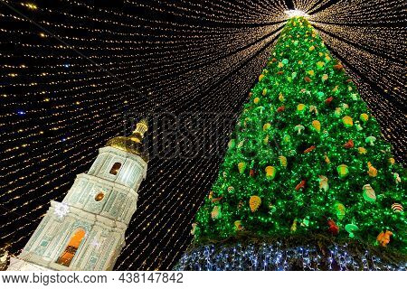 Beautiful Scenic Decorated Christmas Tree With Decorations And Illuminated By Light Garlands Against