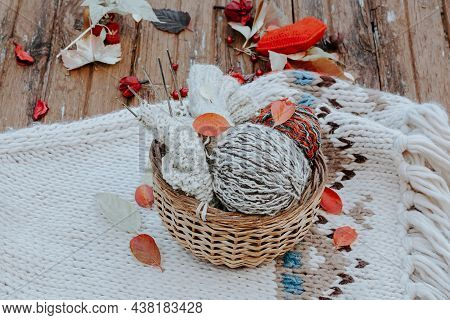 Autumn Knitting Of Warm Clothes. Woolen Balls Of Knitting Needles Knitted Hearts. Self-made Things W